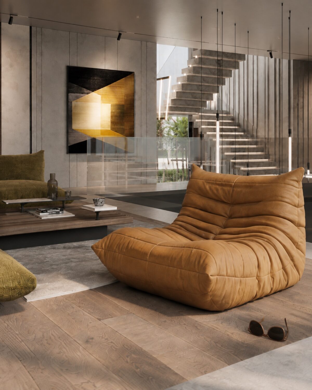 The CT Villa living space with a cognac Togo lounge, olive seating and a floating stone stair